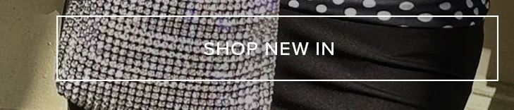 Sparkling silver-tone top paired with a black outfit featuring a polka dot detail, inviting users to shop the latest new arrivals.