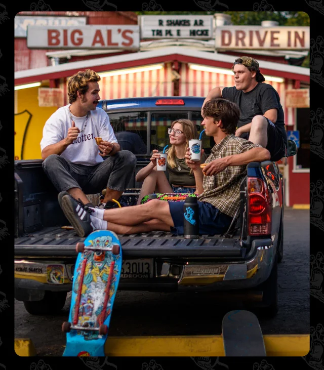 Skateboarders in pickup truck with pints