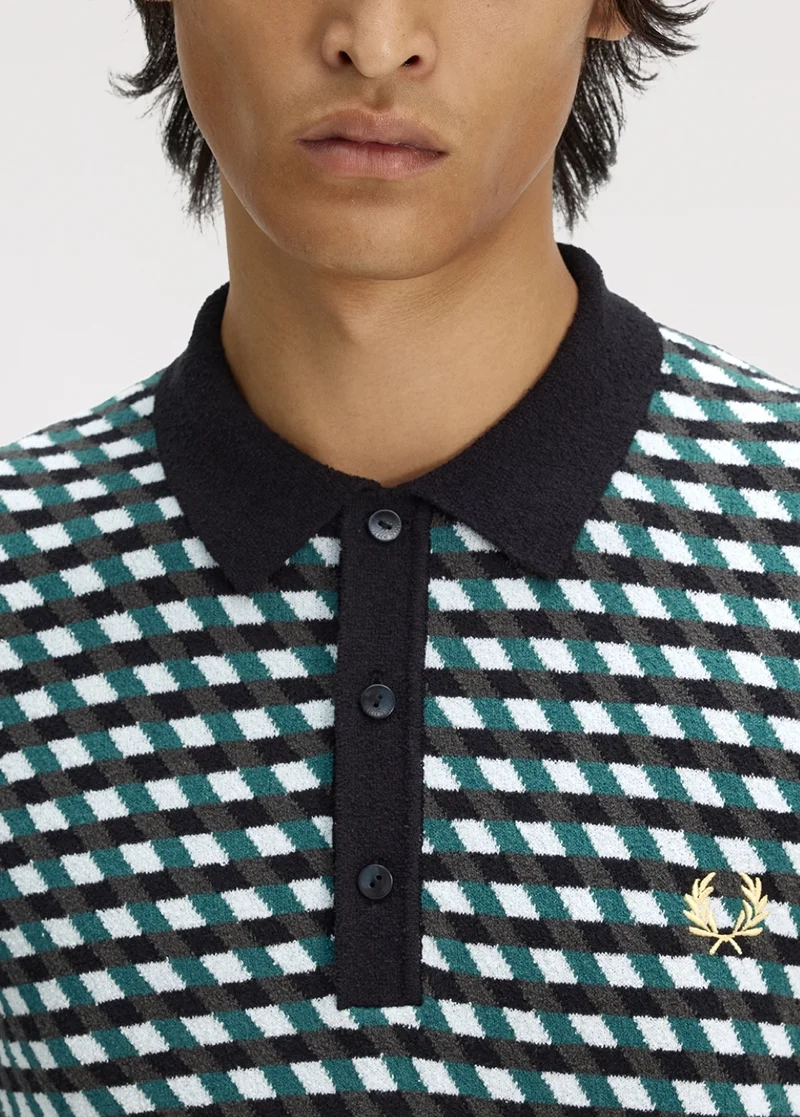 A close up of a male model wearing a Fred Perry Geometric Knitted Shirt in Light Ice