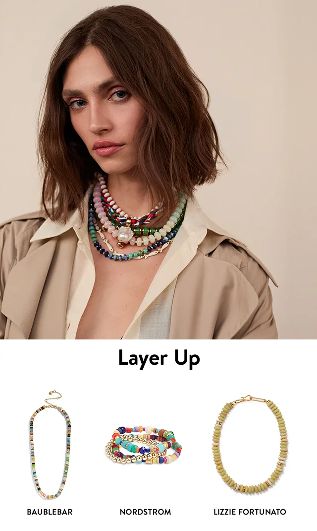 A woman wearing several beaded necklaces. A beaded BaubleBar necklace, beaded Nordstrom bracelets and beaded Lizzie Fortunato necklace.