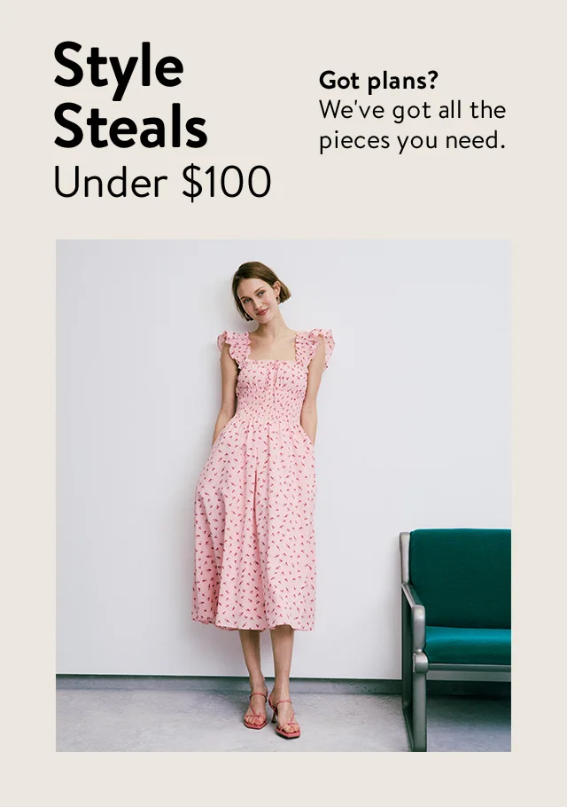 A woman wearing a pink floral-print midi dress.