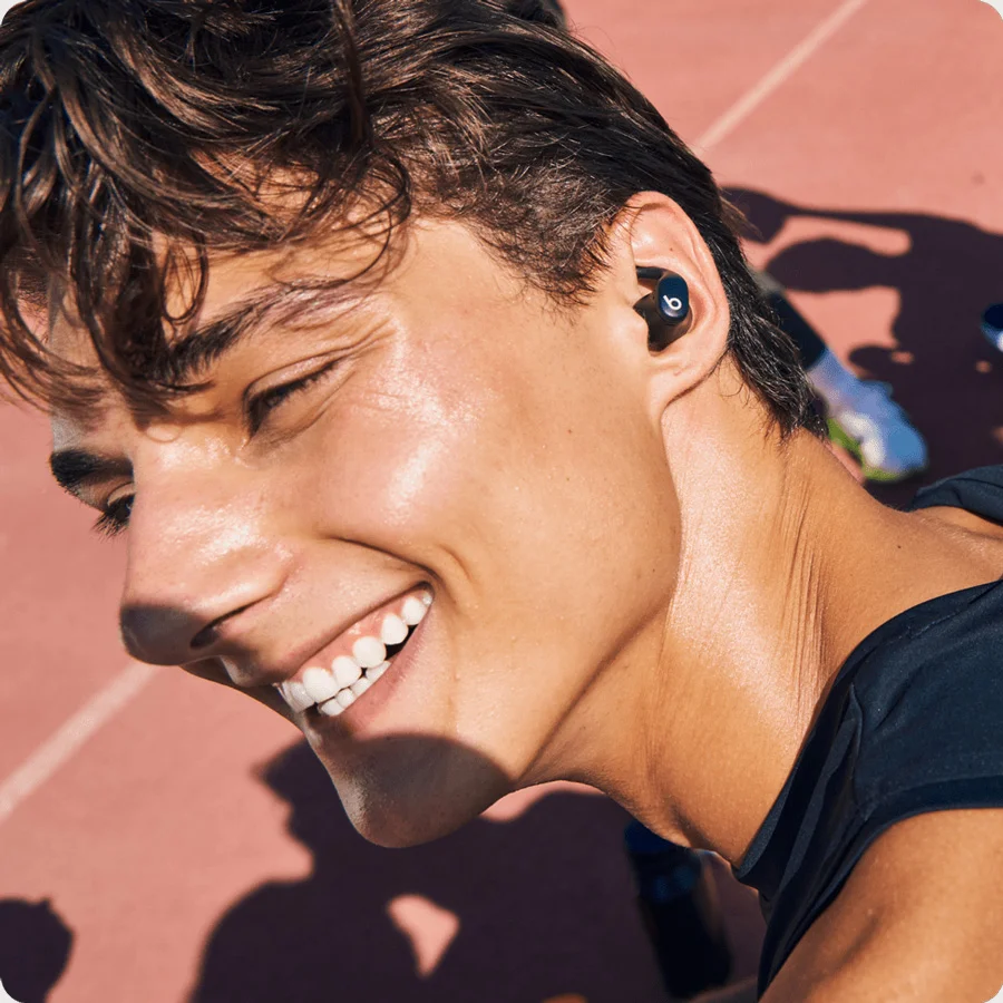 Person wearing the Powerbeats Fit earbuds demonstrating it's sweat and water resistance