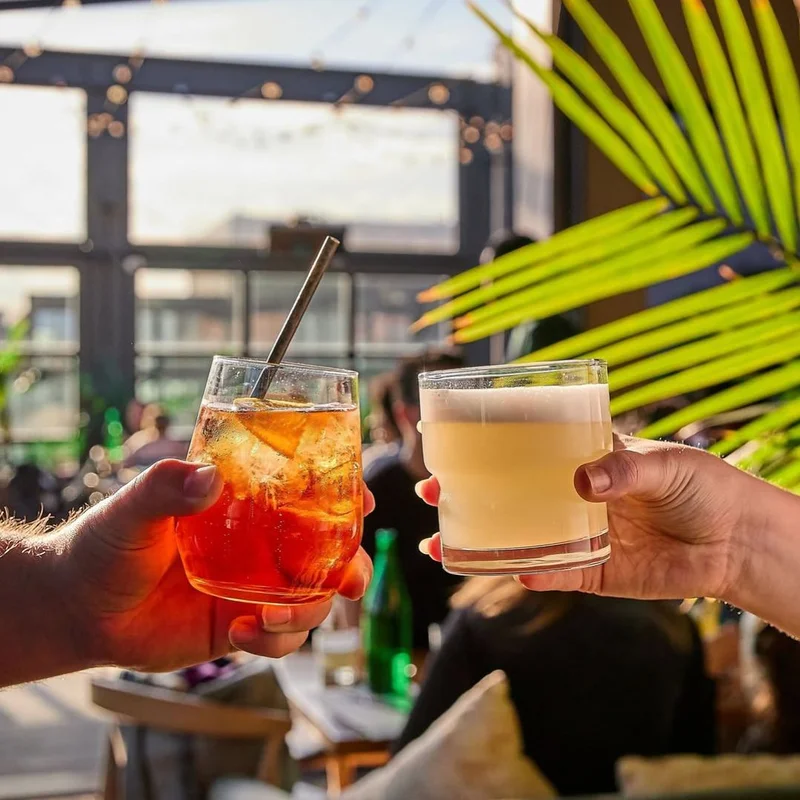 Clinking cocktails in the sun