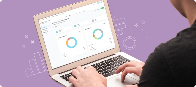 A person working on their laptop. The laptop screen shows a report from Litmus's analytics.