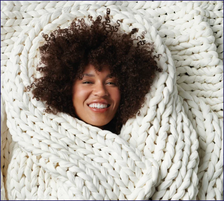 woman using Purple® weighted blanket