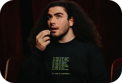 Model wearing a black festival branded hoodie.