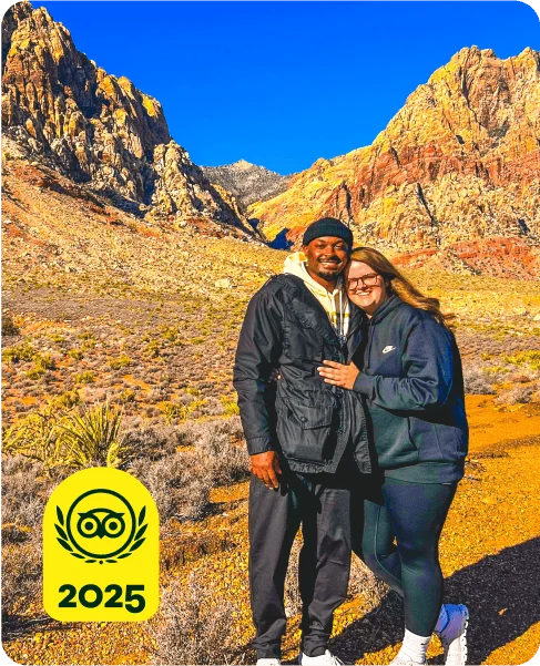 Image Description: Two people posing in front of desert mountains. A yellow 2025 Travelers’ Choice Awards Best of the Best badge is on the bottom left corner of the image.