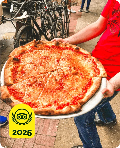 Image Description: A person holding a large pizza. A yellow 2025 Travelers’ Choice Awards Best of the Best badge is on the bottom left corner of the image.