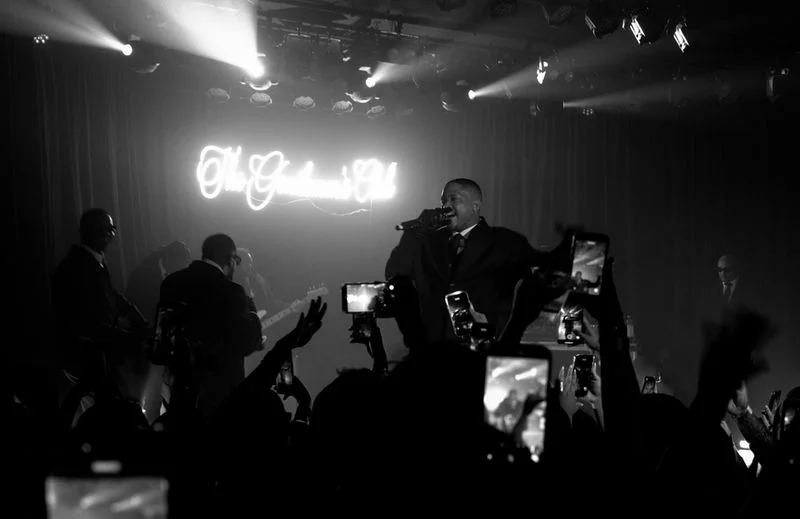 Image may contain: YG, Lighting, Concert, Crowd, Person, Adult, Wedding, Urban, Electronics, Mobile Phone, Phone, and Face