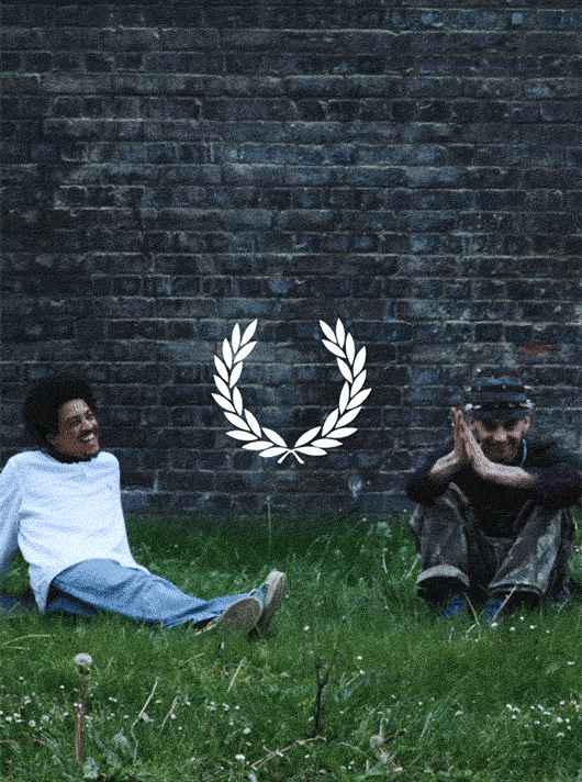 A group of young adults hanging out, laughing, having fun, wearing Fred Perry shirts.
