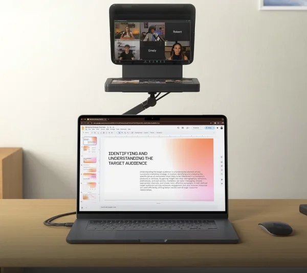 Elgato Prompter mounted on Elgato Desk Stand behind a laptop with a presentation on screen.