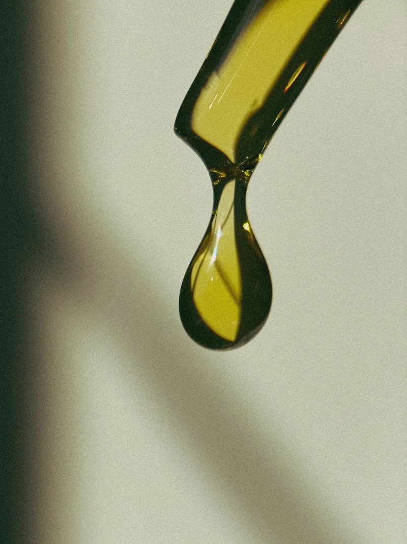 A close up of a golden drop of oil.