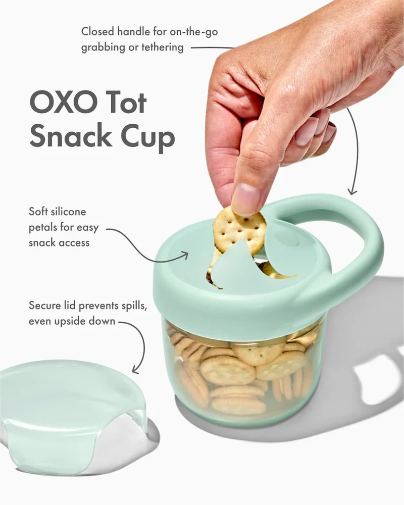 Closed handle for on-the-go grabbing or tethering. OXO Tot Snack Cup. Soft silicone petals for easy snack access. Secure lid keeps prevents spills, even upside down.