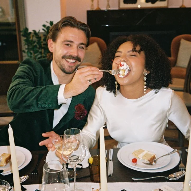 A happy couple eating cake