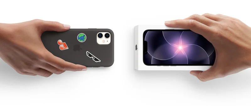 Hands of two different people exchanging a used iPhone with a new iPhone