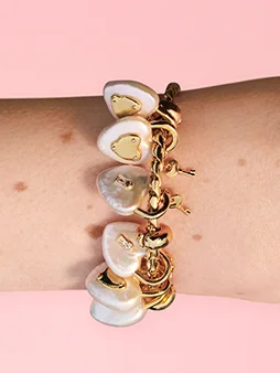 Close up of several lock and key charms on a bracelet