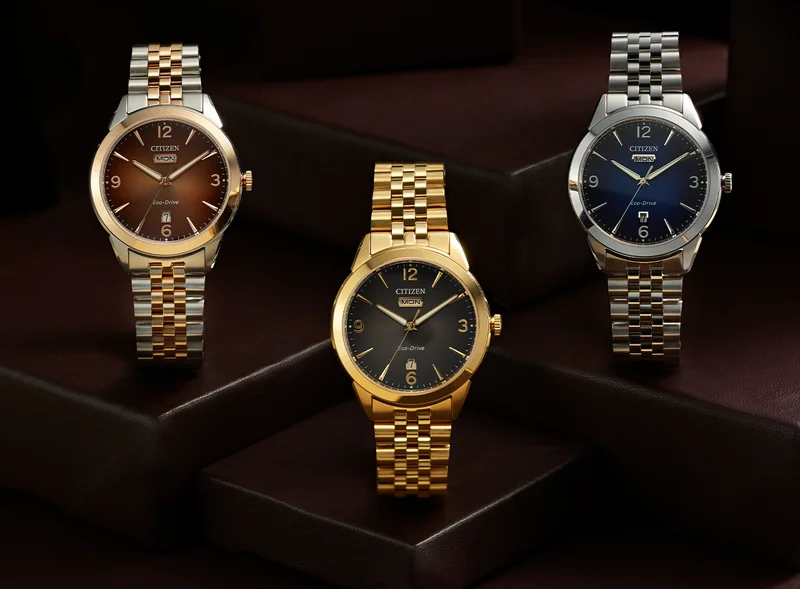 Images of three new Rolan watches sitting on top of dark brown leather box displays