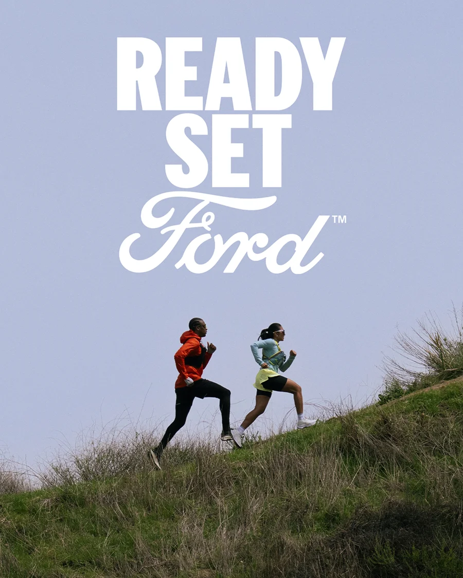 Two people running up a grassy hill. "Ready Set Ford™" is on the image.