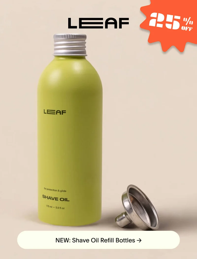 A green bottle of Shave Oil with a metal funnel sitting next to it