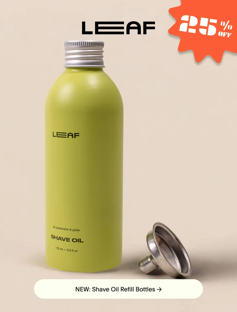 A green bottle of Shave Oil with a metal funnel sitting next to it