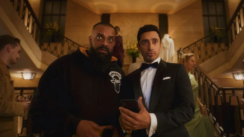 Image may contain: Guz Khan, Riz Ahmed, Clothing, Formal Wear, Suit, Blazer, Coat, Jacket, Tuxedo, Face, Head, and Person