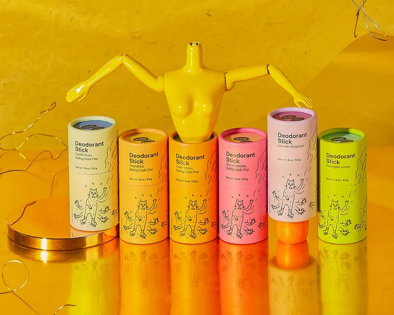 A rainbow of deodorant sticks with a barbie torso on top