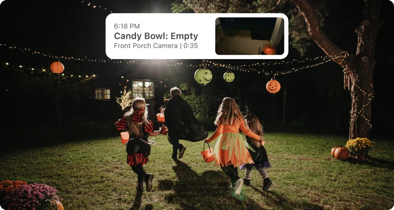 Kids in Halloween costumes running through a yard. A simulated image of an Arlo Secure feed event overlays the image with text: 6:18PM, Candy Bowl: Empty, Front Porch Camera, 0:35 with an point-of-view image showing an empty candy bowl on a front porch.