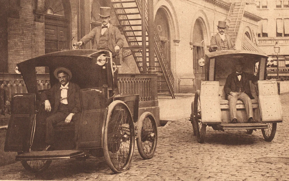 An archival image of two Electrobat taxis in New York