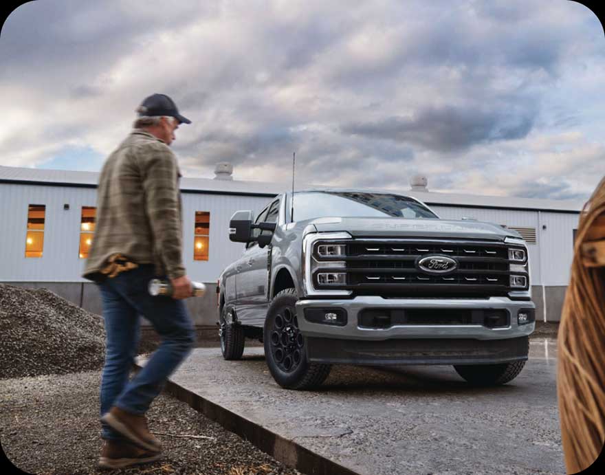 A man walking by a Ford F-150.