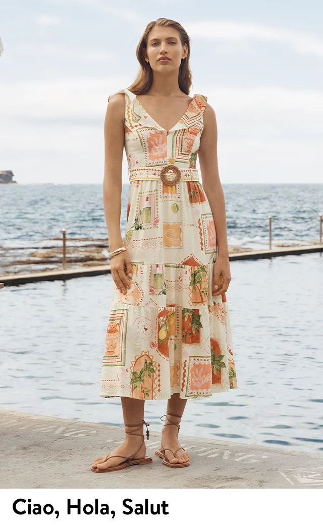 A woman wearing a printed belted midi dress.