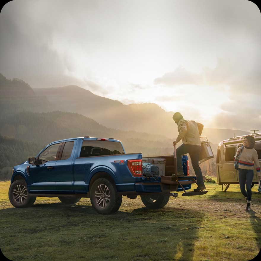 A Ford F-150 being unloaded in a field.