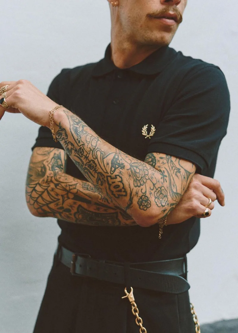 Male wearing a black M3 Fred Perry Shirt in Black Champagne