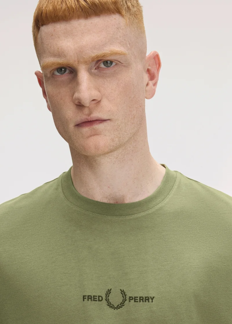 Male model wearing an embroidered Fred Perry T-Shirt in Olive Mint