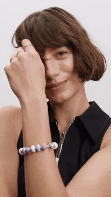 Model wearing fully loaded Murano charms on bracelet