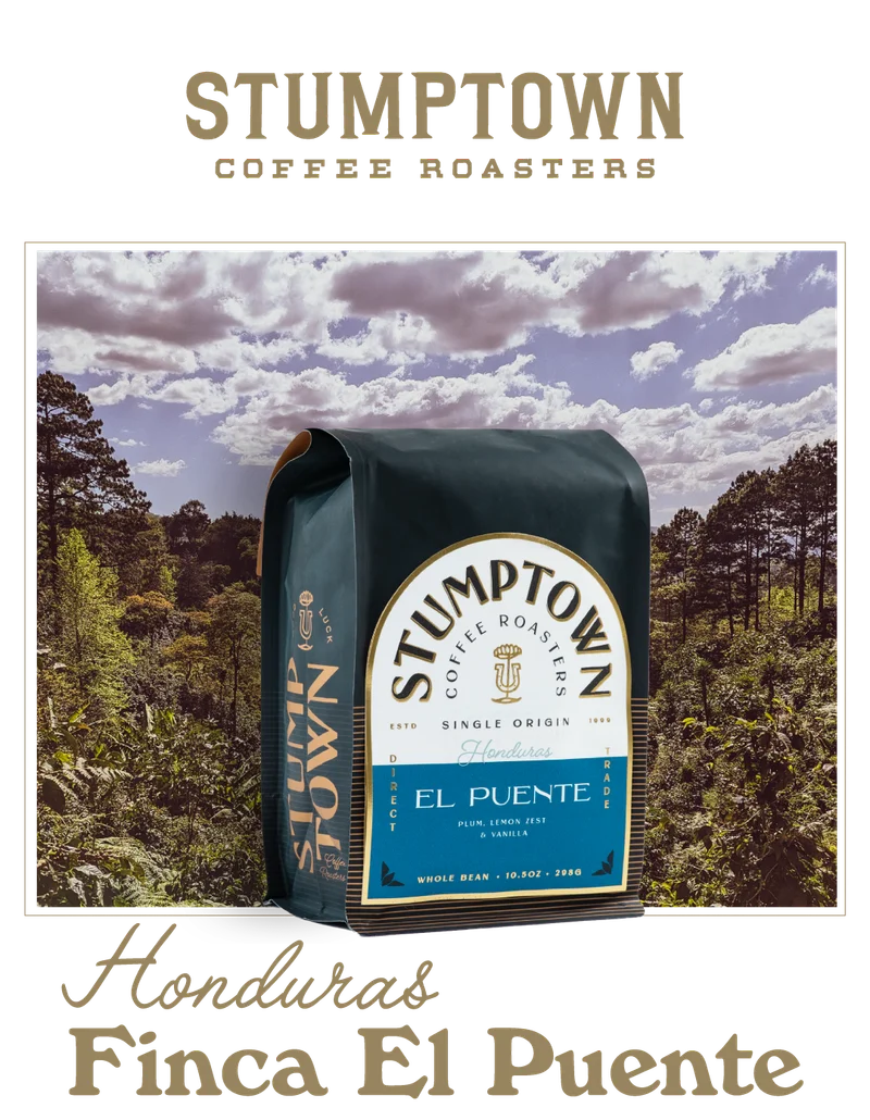 A bag of Stumptown Honduras Finca El Puente whole bean coffee is shown in front of a lush coffee farm landscape with cloudy blue sky. Text below reads “Honduras Finca El Puente.”