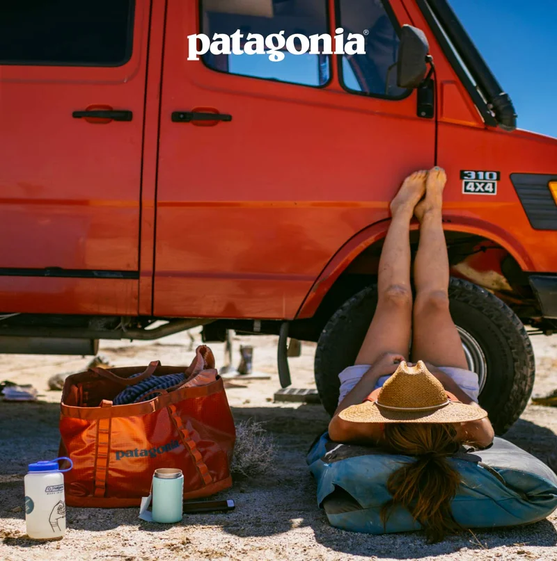 Patagonia. A person rests in the shade of a truck.