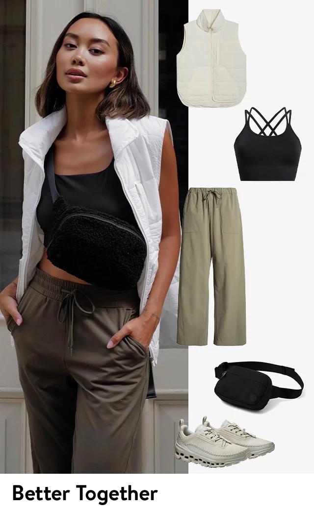 A woman a white vest, black tank, black bag, brown pants and white sneakers.