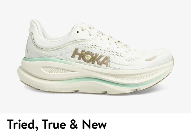 A white sneaker with green accents.