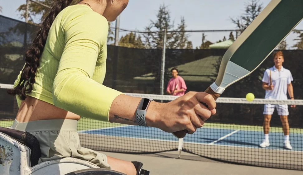 picture of people playing a game wearing a fitbit watch