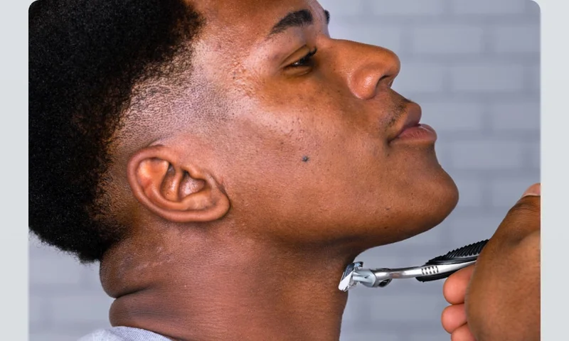 Man shaving his neck with SkinGuard razor