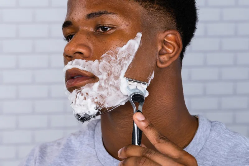 Man shaving his face with SkinGuard razor