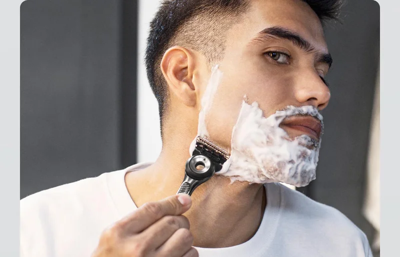 A man shaving his beard with GilletteLabs with Exfoliating Bar Razor