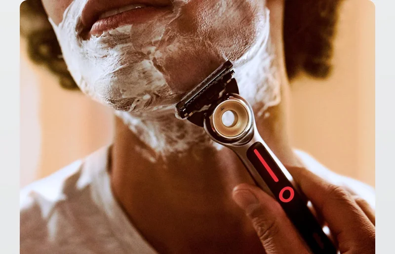 A man shaving his beard with GilletteLabs Heated Razor Starter Kit