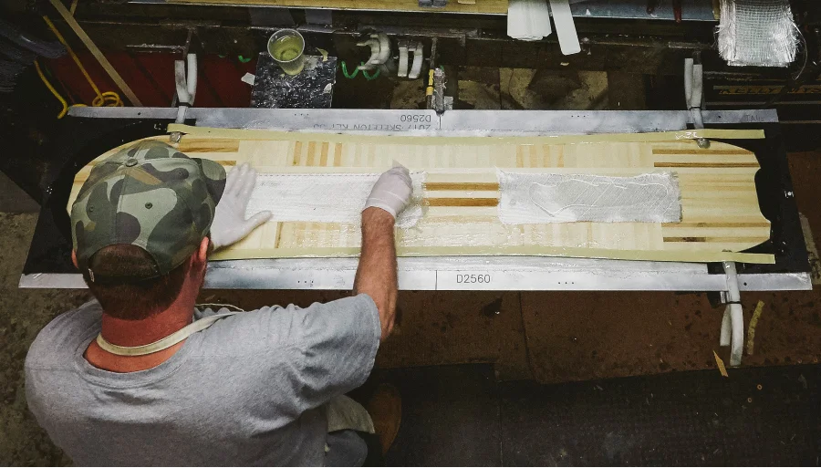 Craig's employee making a Custom Board in the factory