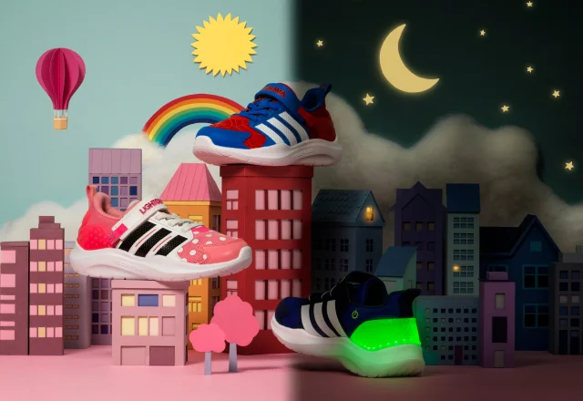 three pairs of kids shoes with buildings