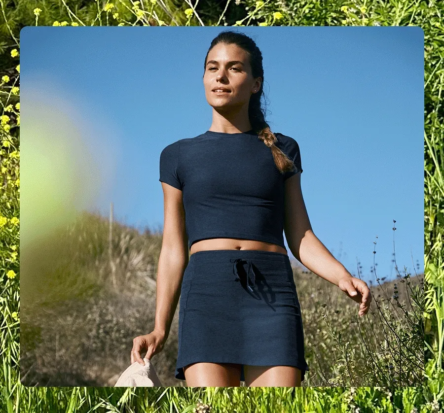 Gif of 3 models - first model is wearing a blue cropped t-shirt and athletic skirt. 2nd model is wearing a brown maxi dress with cutouts at waist. 3rd model is wearing a garden printed cropped tank and biker shorts.