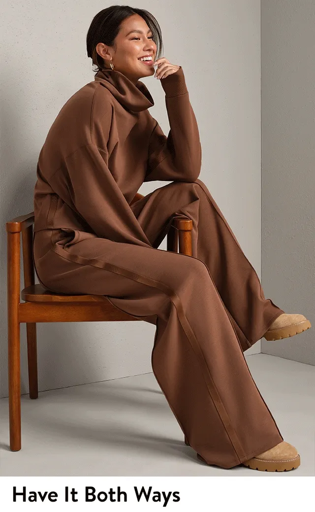 A woman wearing a brown mock neck top and matching trousers.