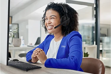 A happy Dell Customer Service team member on a support call.
