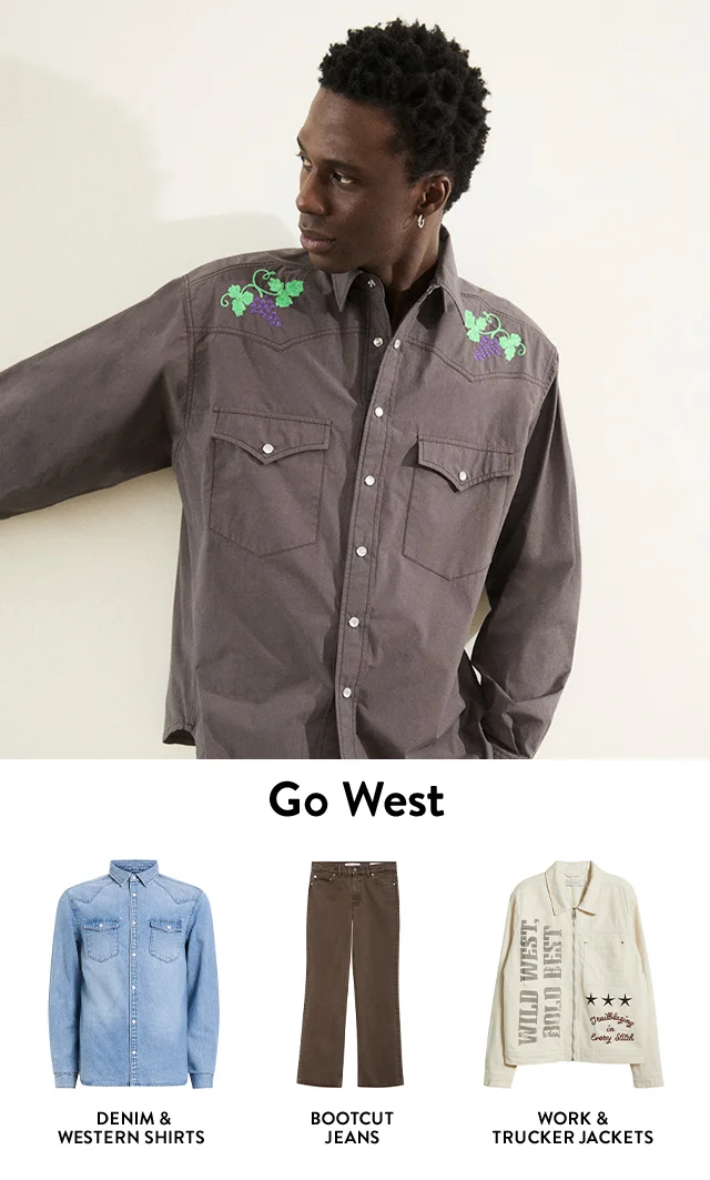 A man wearing a Western-inspired shirt. Western-style denim shirt. Bootcut jeans. Western-inspired work jacket.