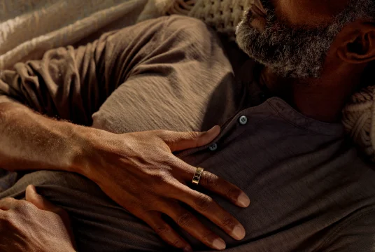 Person laying down with hand on chest wearing Oura Ring
